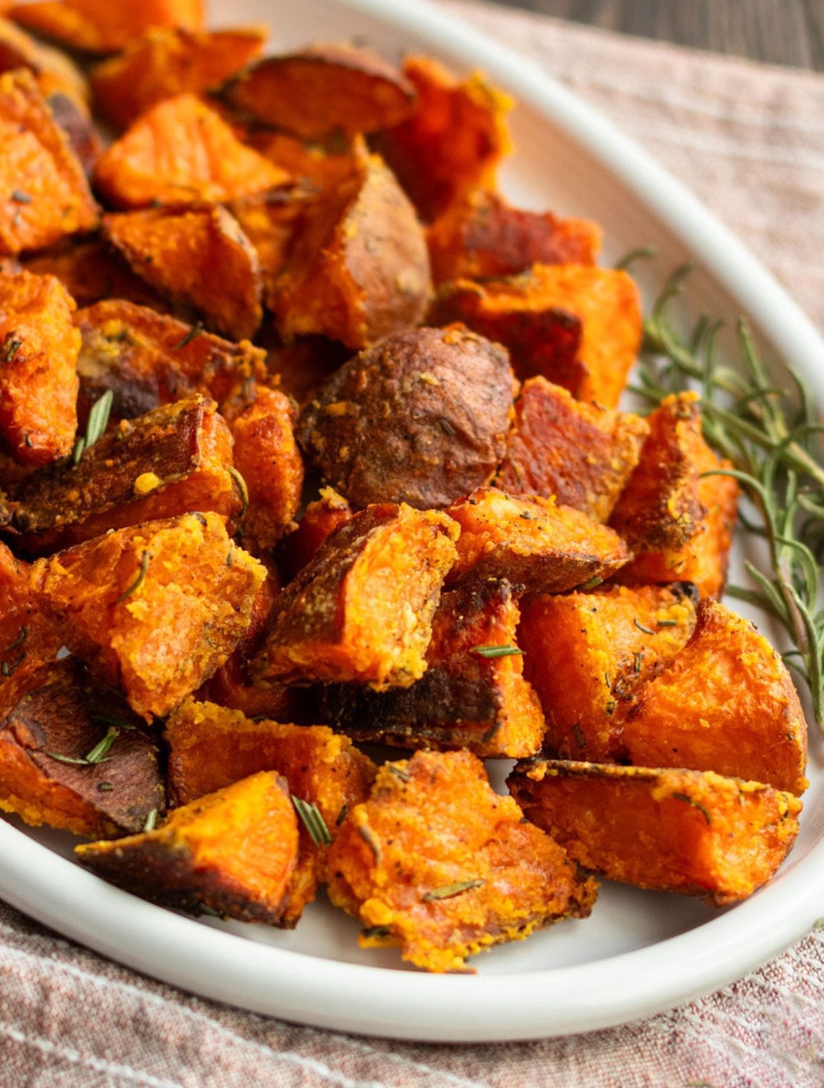 Crispy roasted sweet potatoes piled high on a platter.