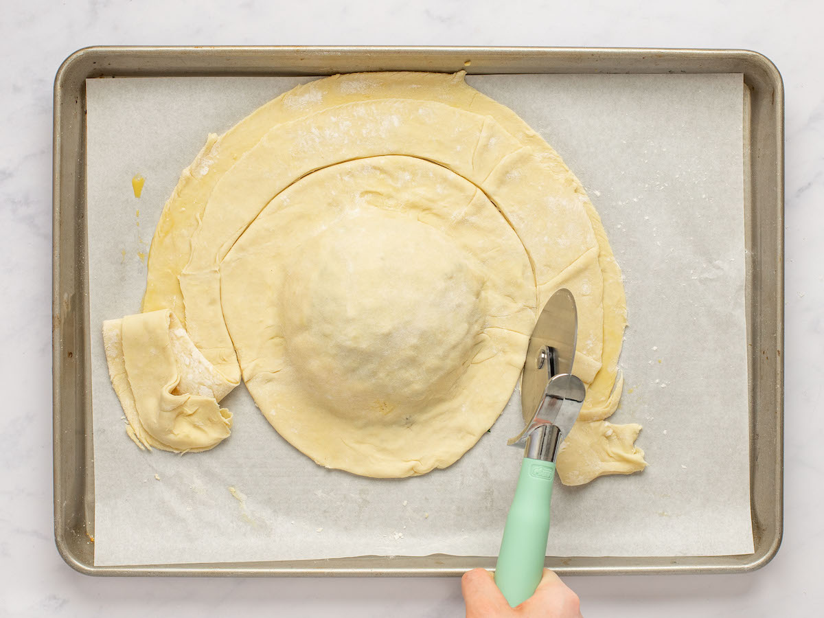 cutting the excess pastry off