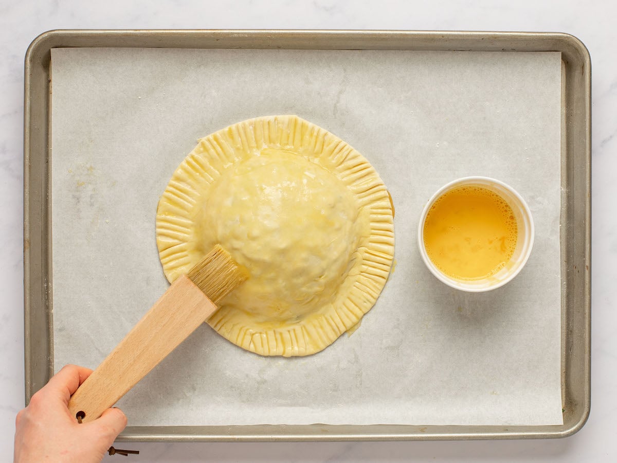 brushing the top of the pastry with the egg wash