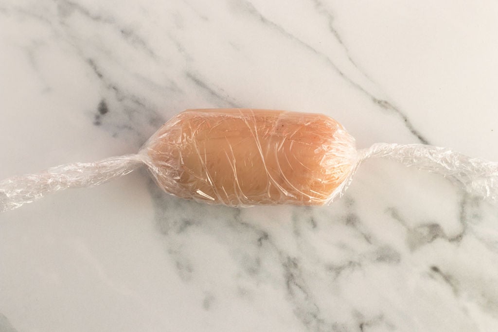 chicken wrapped tightly in plastic wrap.
