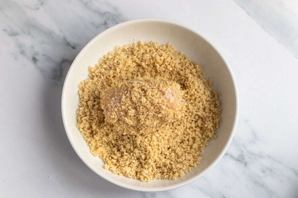rolling chicken breasts in panko mixture