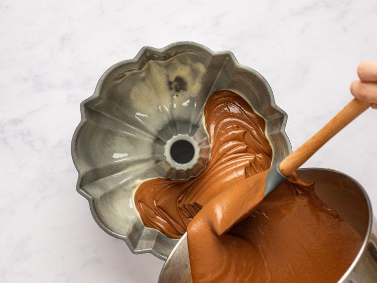 pouring cake batter into bundt pan