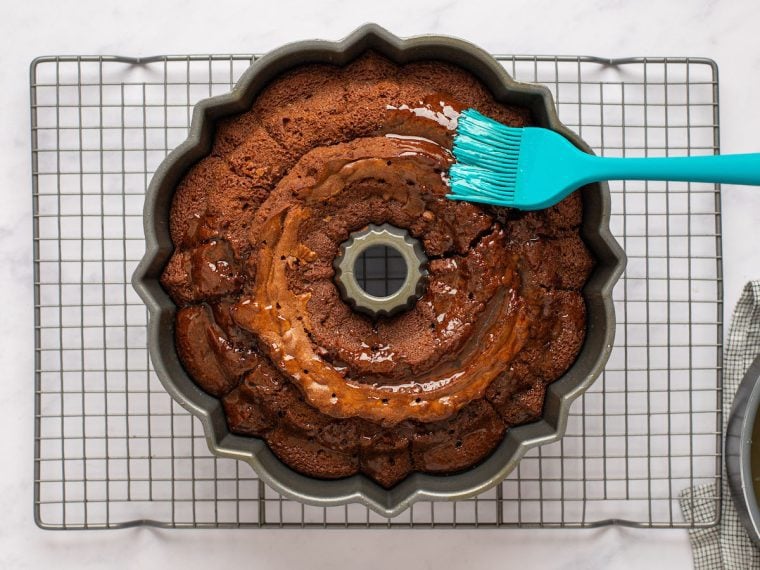 brushing half of glaze on bottom of cake