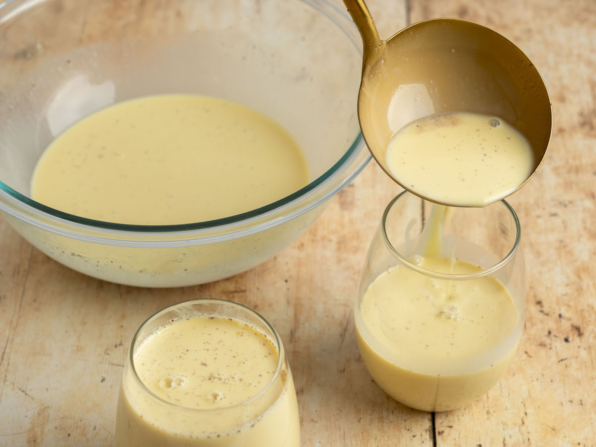 ladling eggnog into glasses