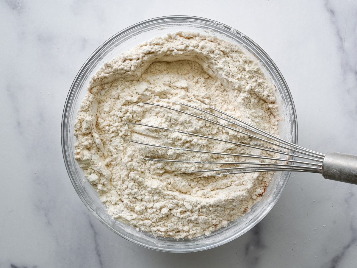 Whisk mixing a bowl of dry ingredients.