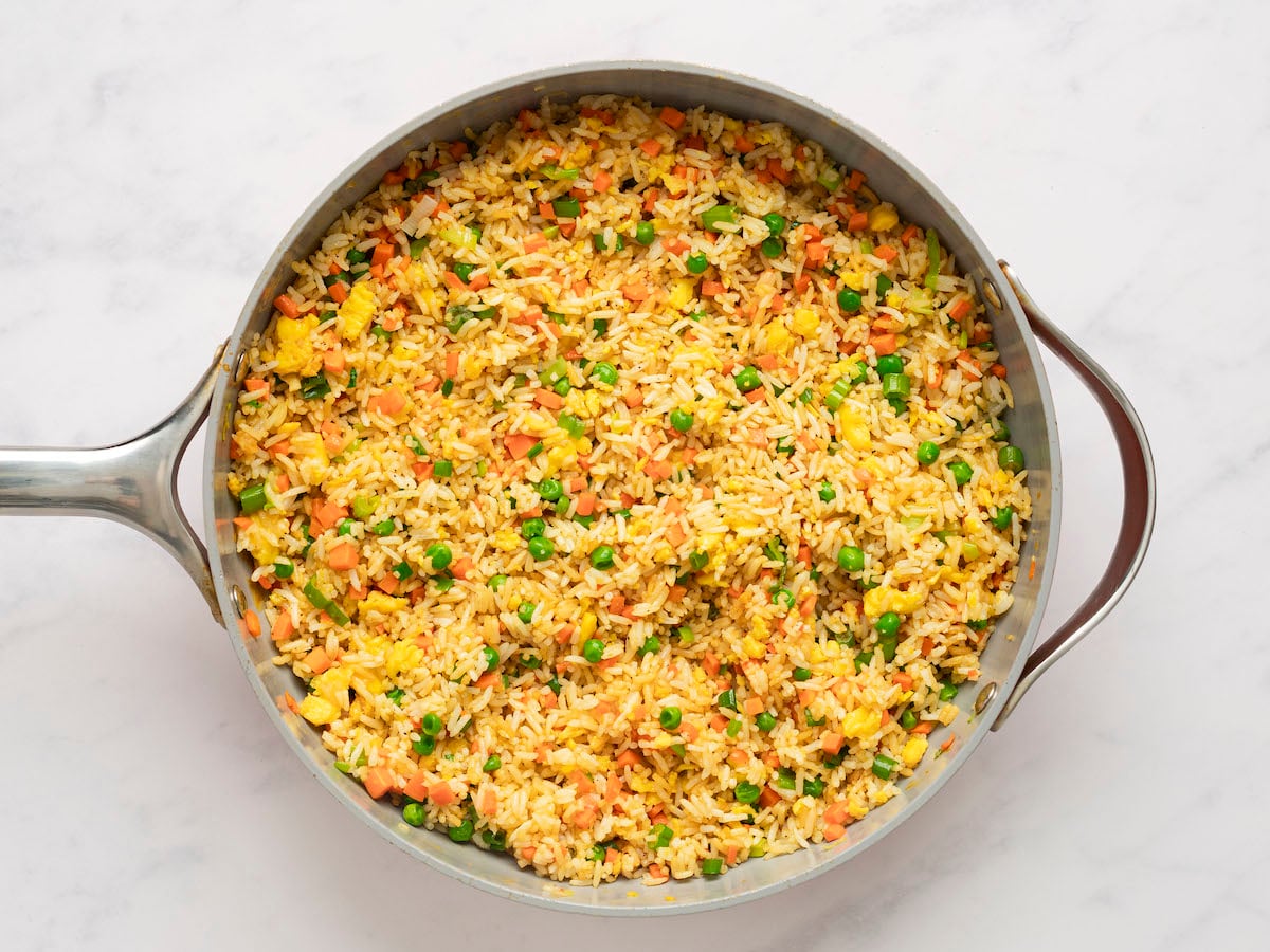 Peas, egg and carrot mixture, dark green scallions, soy sauce, and sesame oil fully combined with rice mixture.