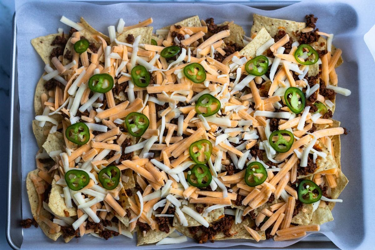 remaining chips, beef, cheese, and jalapeño spread over first layer