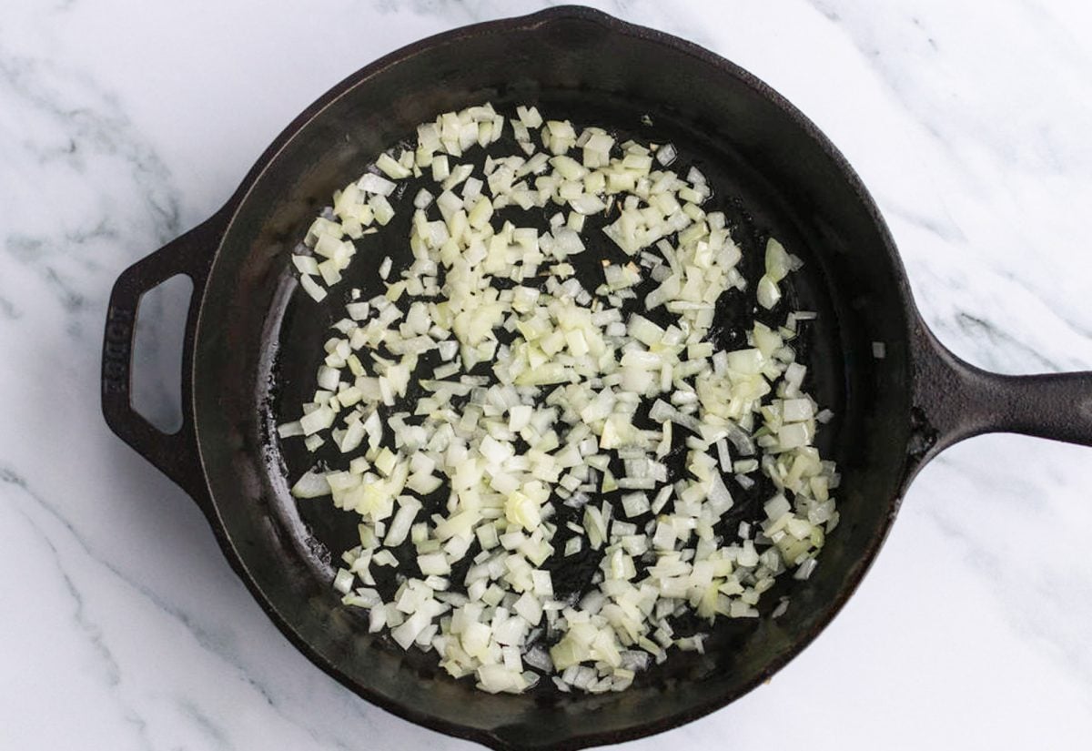 diced onions cooking in skillet