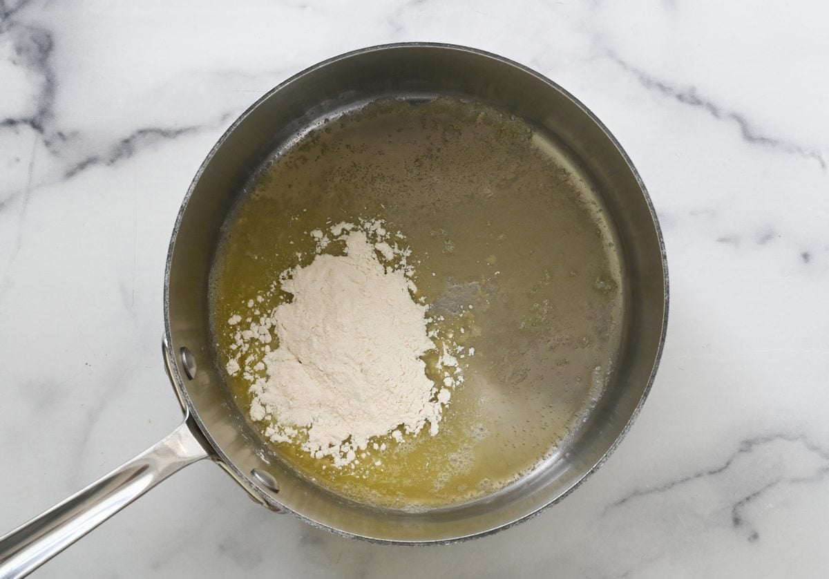 adding flour to melted butter