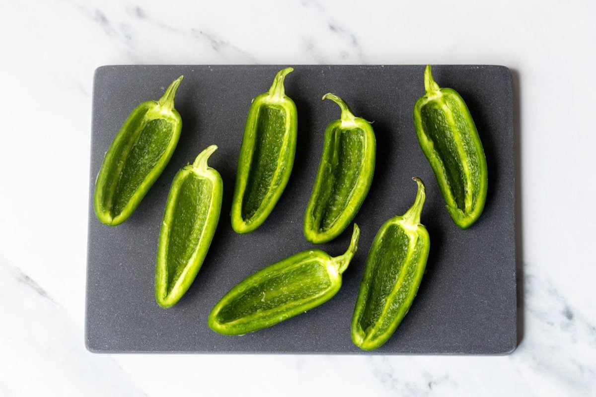 jalapeños cut in half lengthwise with seeds and ribs scooped out