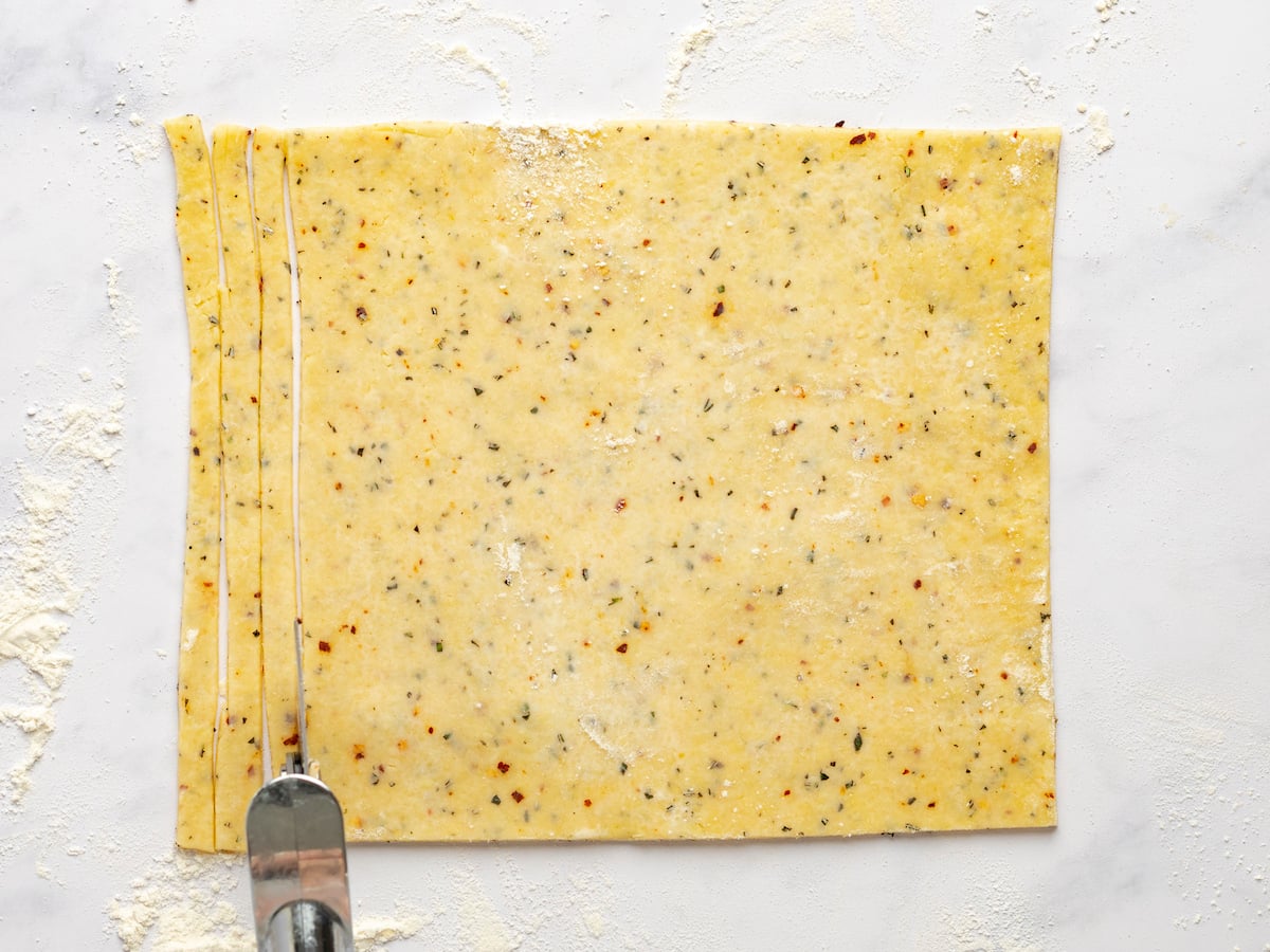 cutting the dough into strips.
