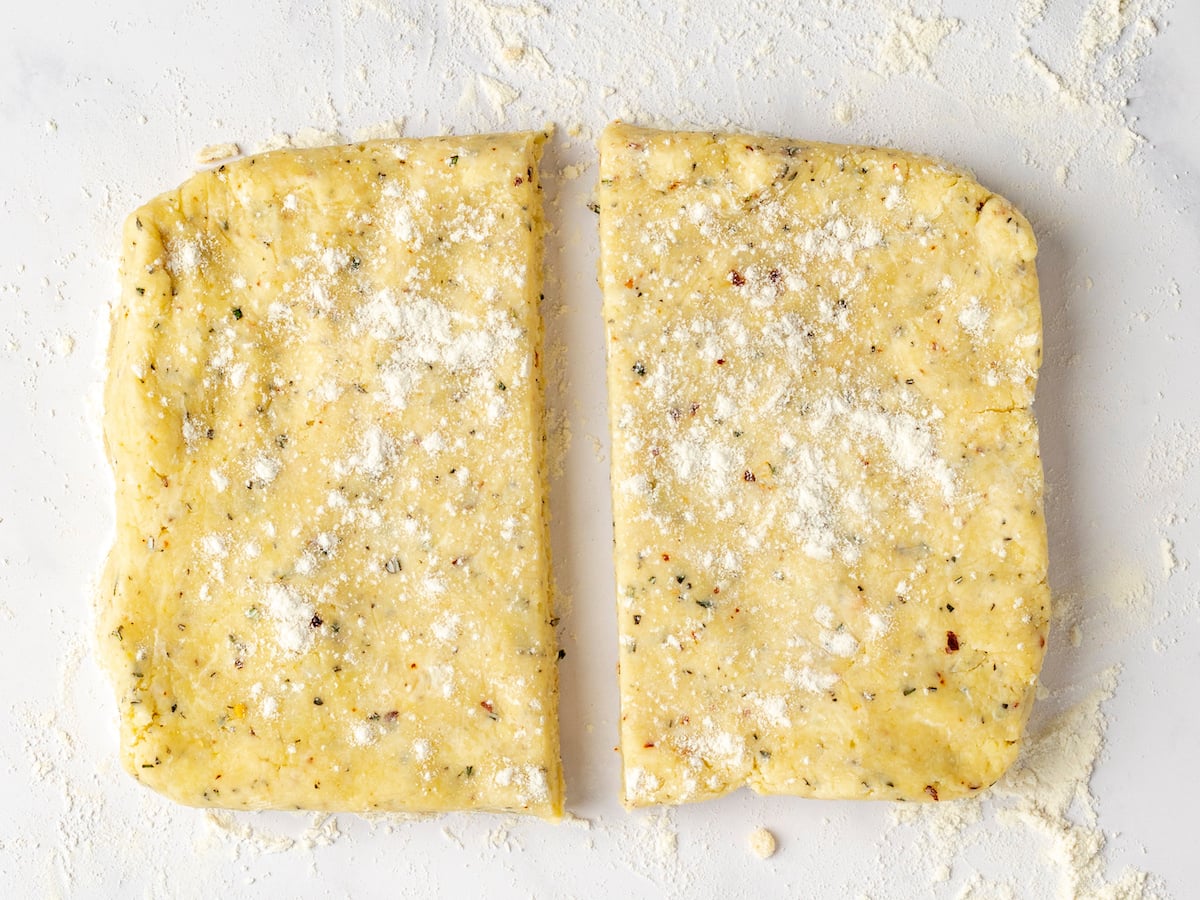 dough divided in half on floured surface.