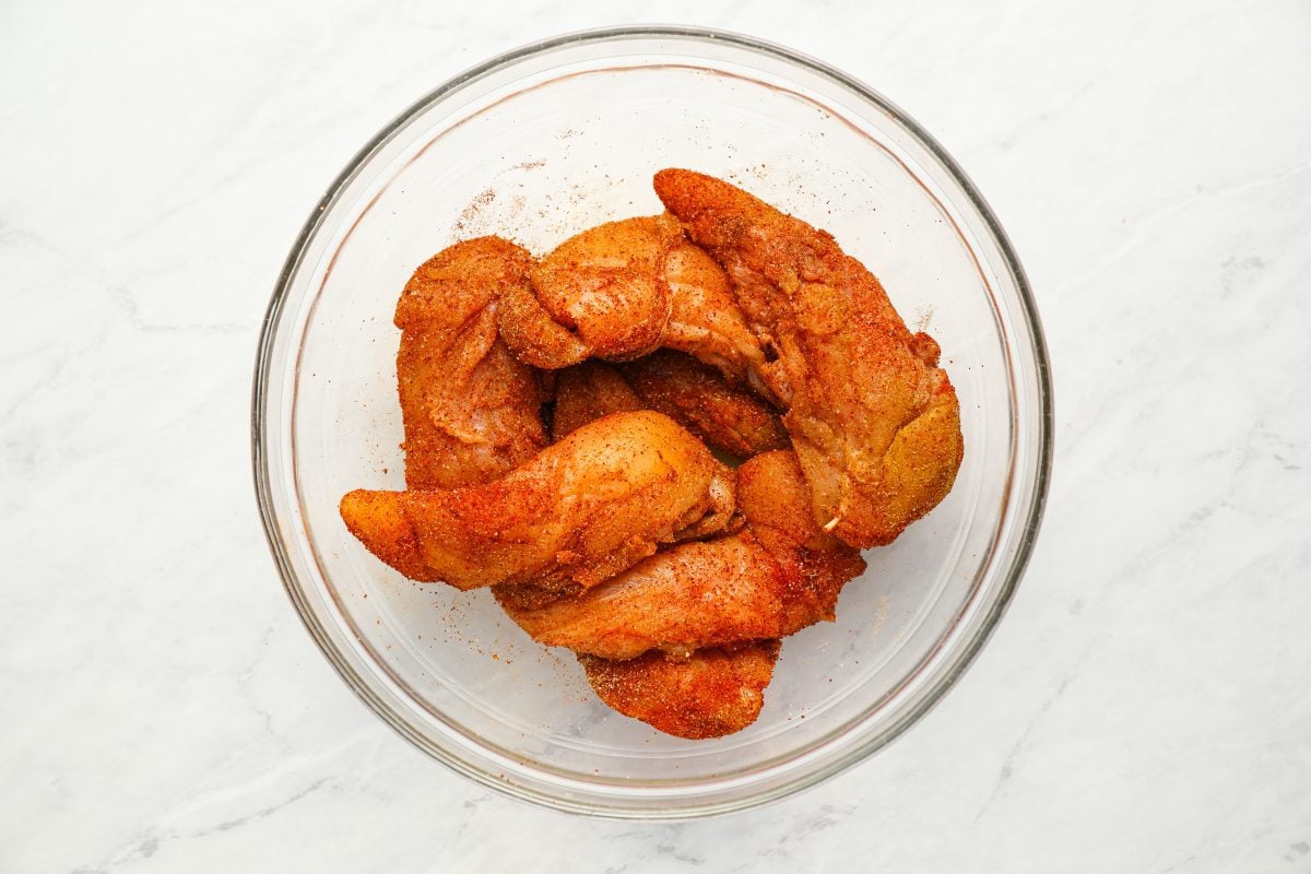seasoned chicken tenderloins in bowl.