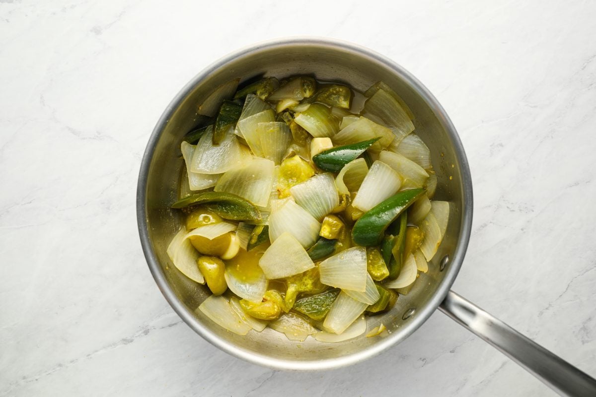 cooked tomatillos and vegetables in pot.