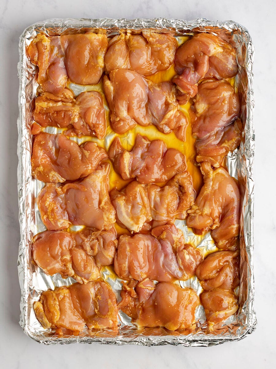 chicken on foil-lined baking sheet ready to broil