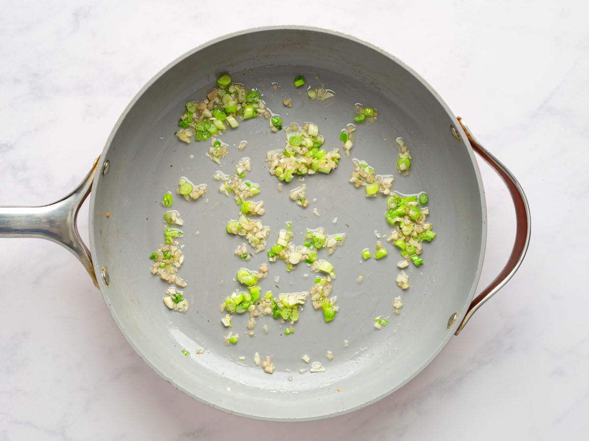 ginger, garlic, and light green scallions in skillet.