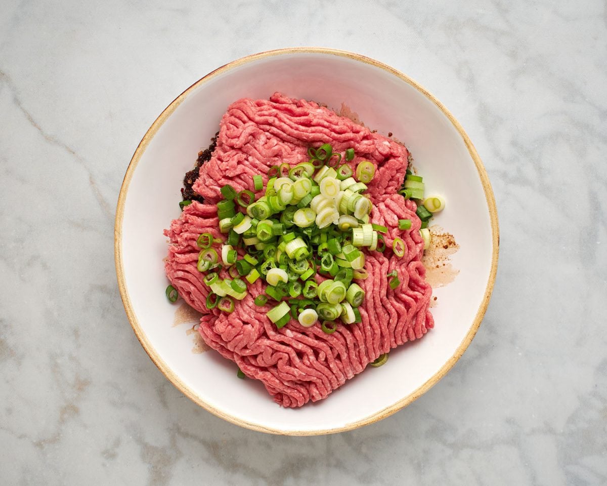 adding beef and scallions to panade mixture