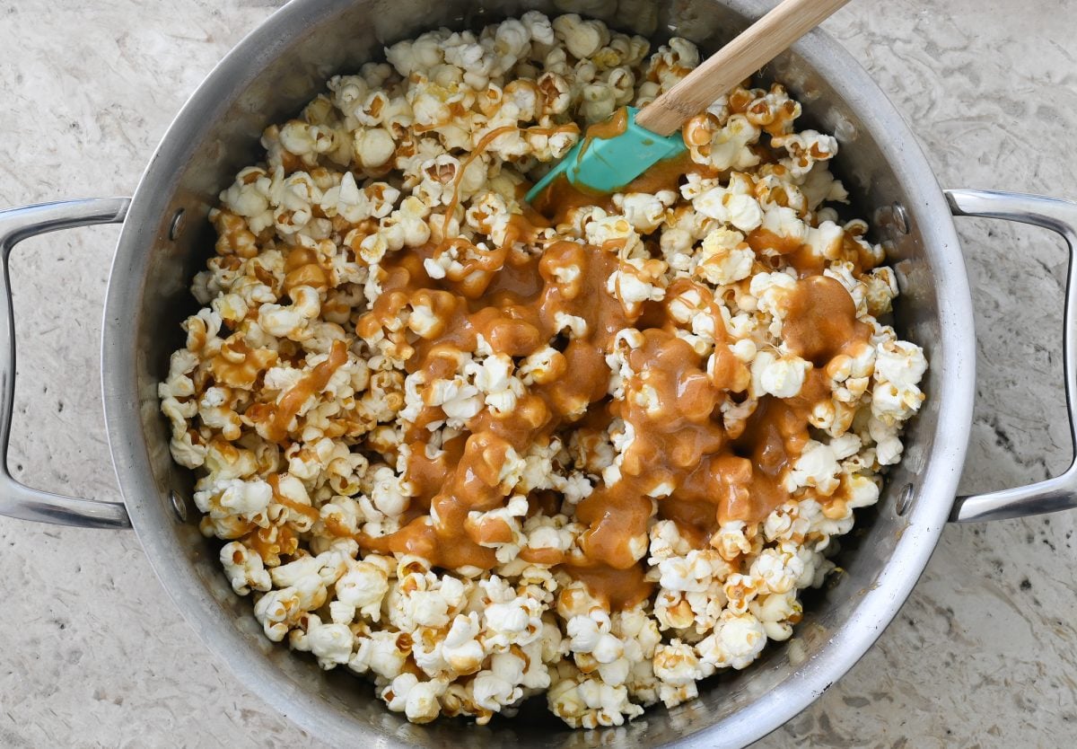 adding caramel to popcorn