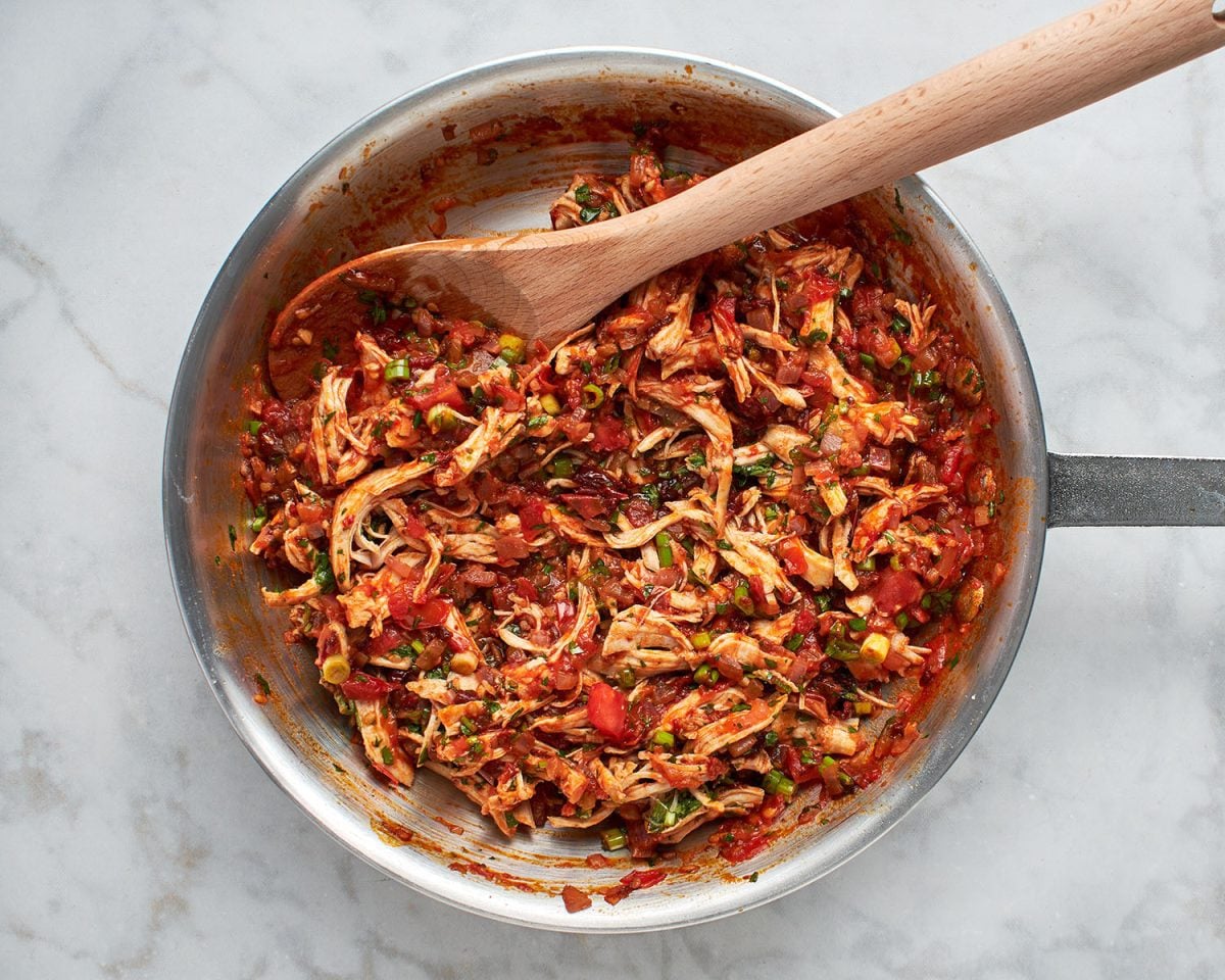 shredded chicken added to the sauce in the skillet