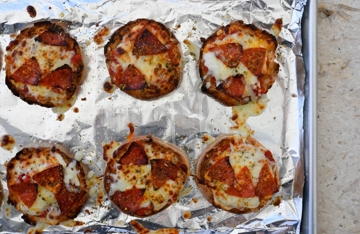 baked English muffin pizzas on baking sheet