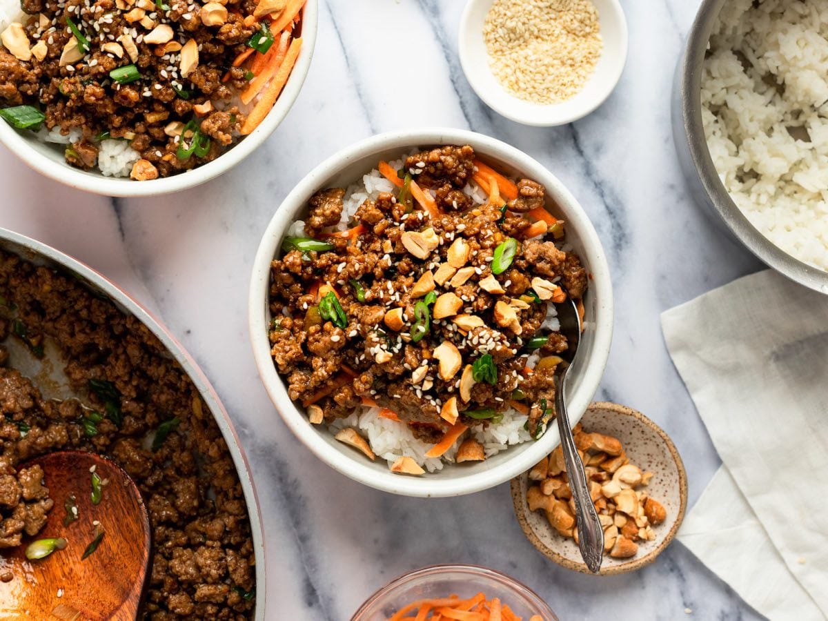 assembling hoisin beef bowls for serving.