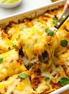 Serving slice of Mexican lasagna.