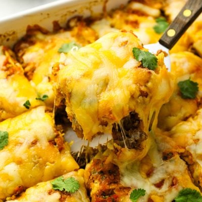 Serving slice of Mexican lasagna.