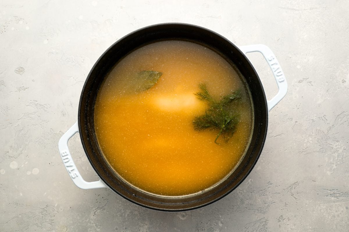 chicken simmering in broth.