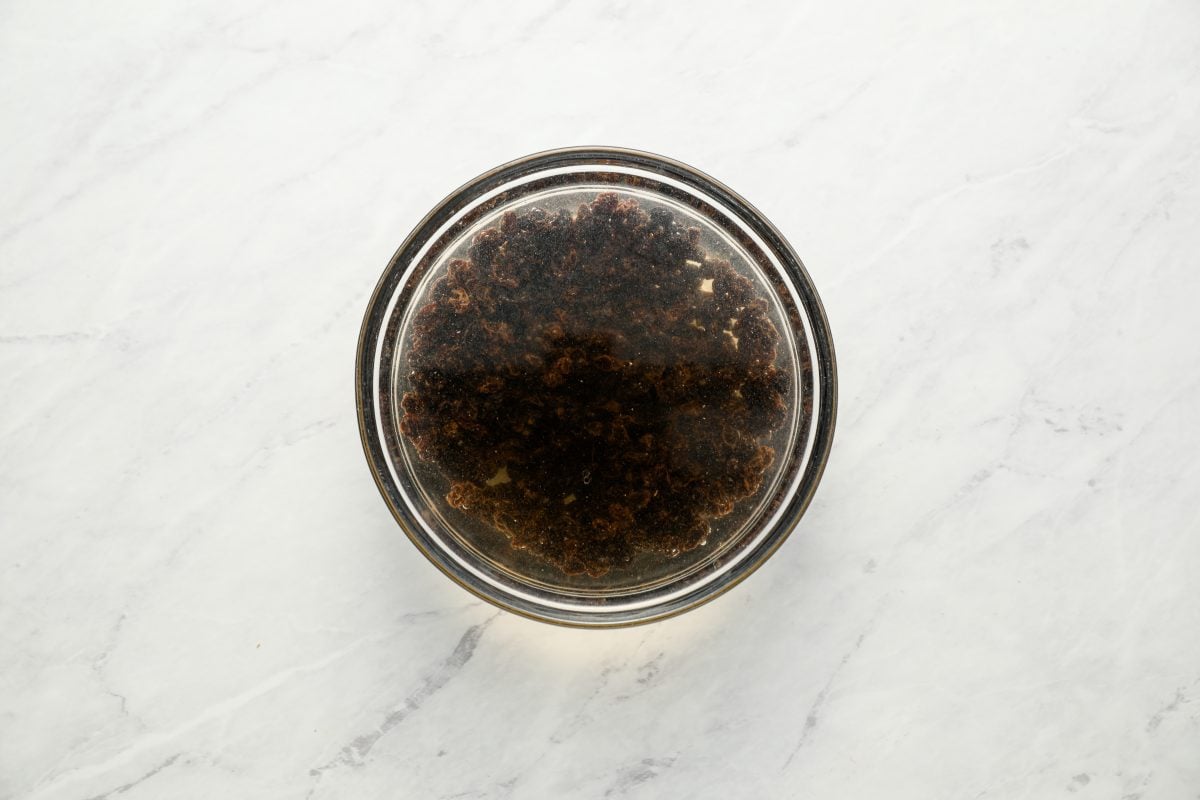 currants soaking in small bowl of hot water.
