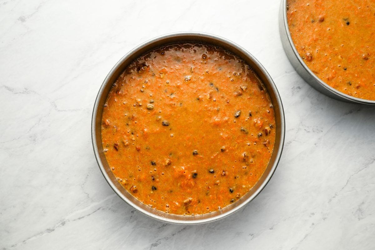 carrot cake batter in cake pans.