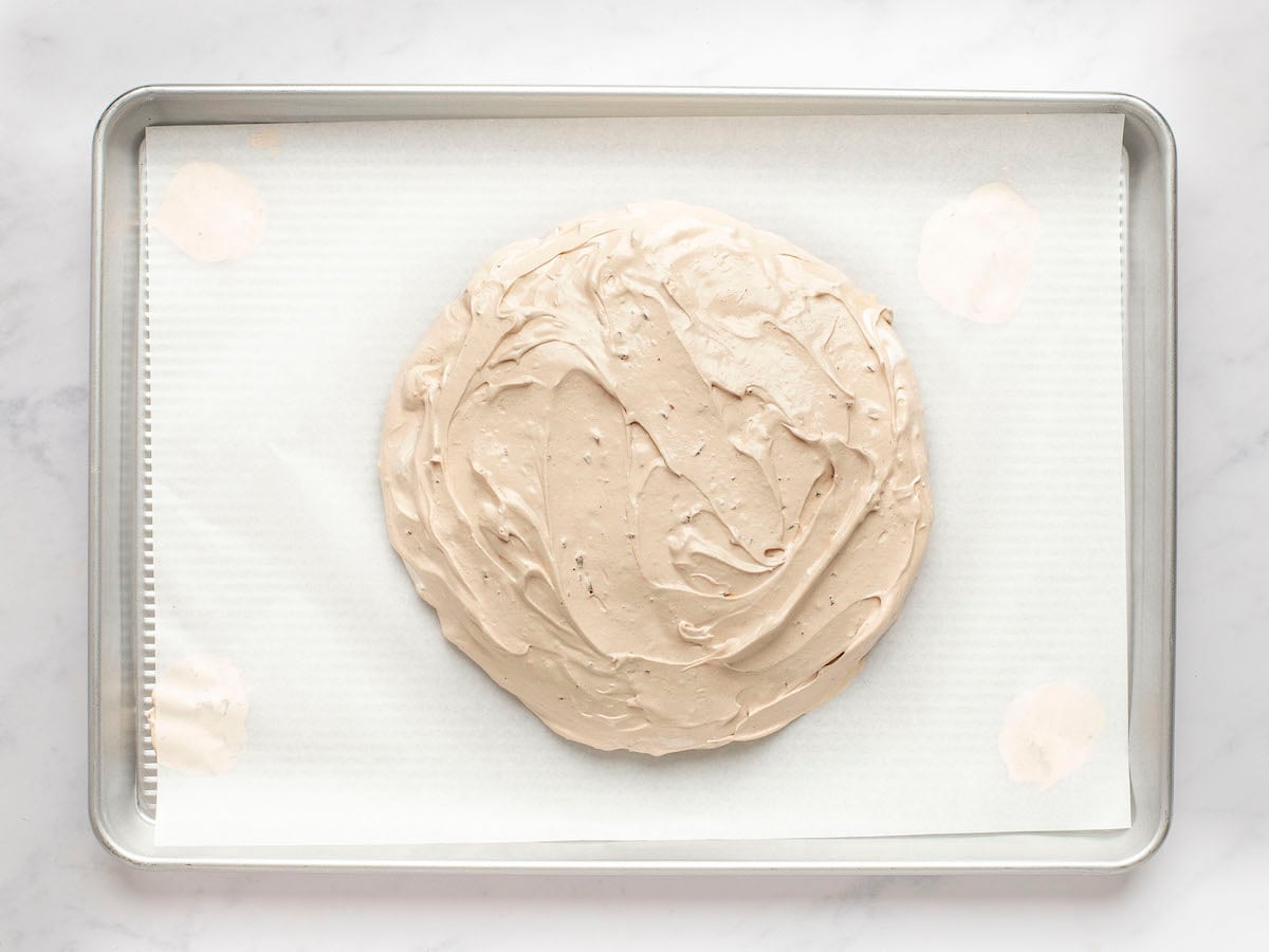 chocolate pavlova mixture shaped on parchment-lined baking sheet.
