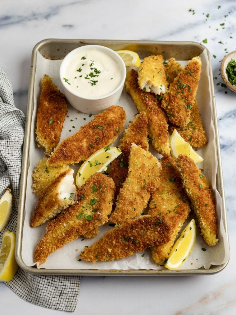 pan fried fish fingers on baking sheet with garlic lemon mayo
