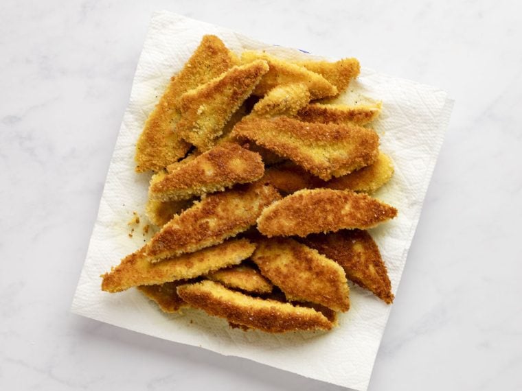 fried fish on paper-towel lined plate