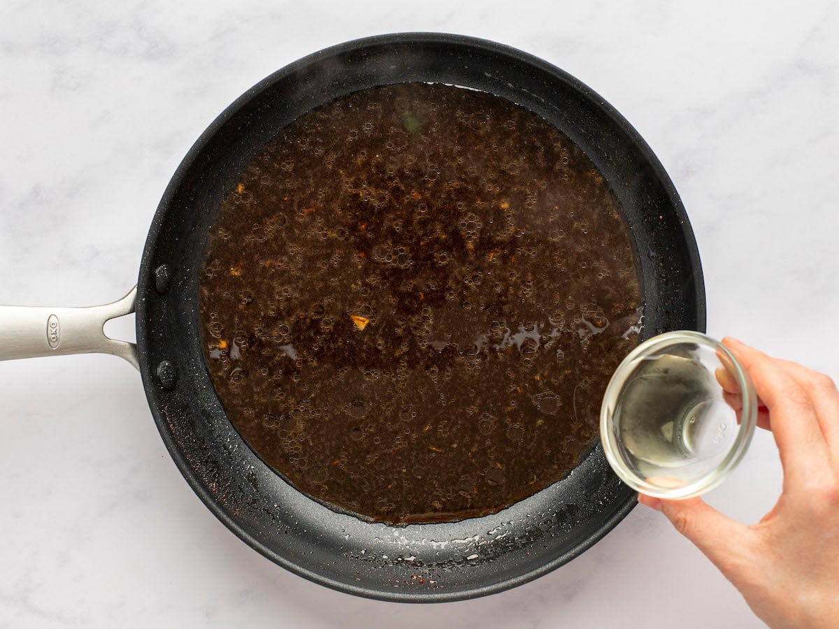adding rice vinegar to teriyaki sauce.