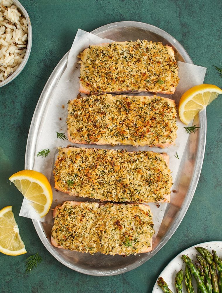 baked salmon on platter served with asparagus and rice
