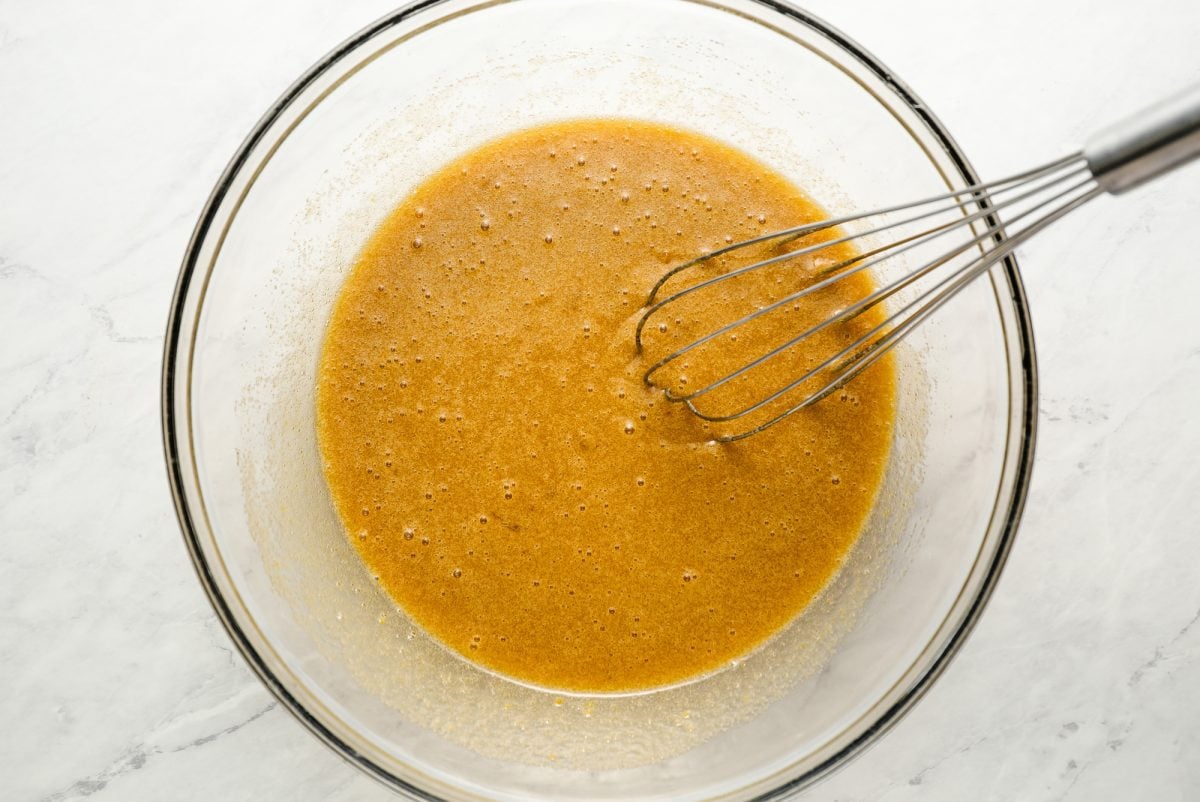 eggs, sugar, brown sugar, and oil whisked in bowl.