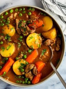 lamb stew in bowl with striped napkin