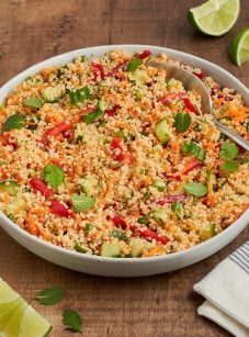Thai quinoa salad with fresh herbs and lime vinaigrette in a square bowl.