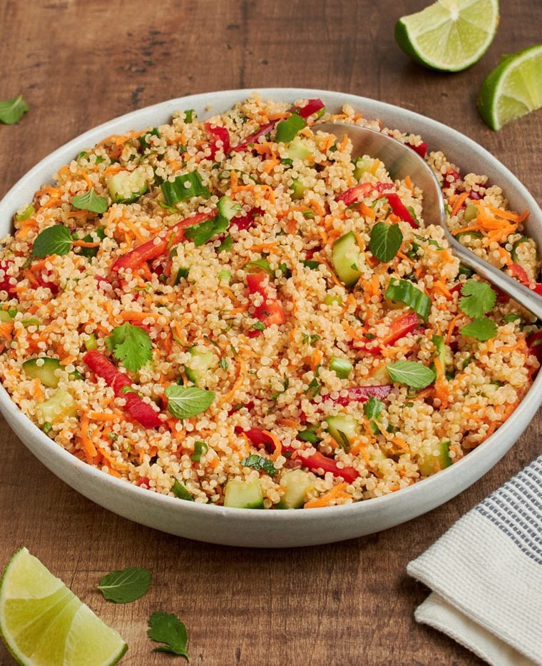 Thai quinoa salad with fresh herbs and lime vinaigrette in a square bowl.
