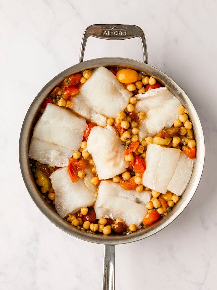 Cod put in large pan with tomato chickpea mixture