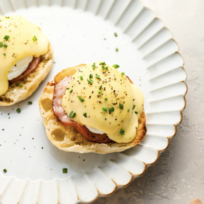 fully prepared eggs Benedict on white plate