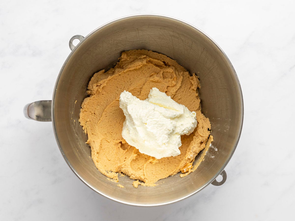 adding some of the whipped cream to lighten the peanut butter mixture.