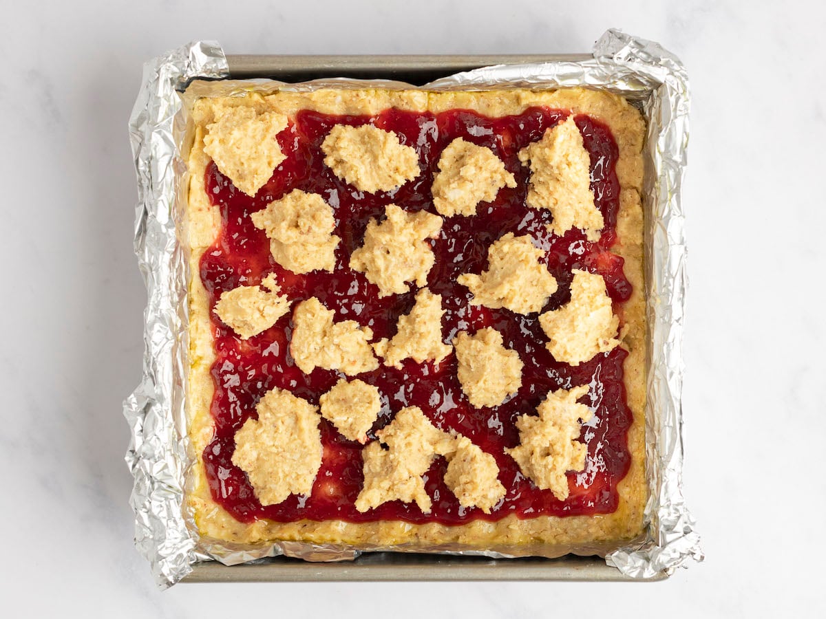 remaining dough dropped onto jam layer.
