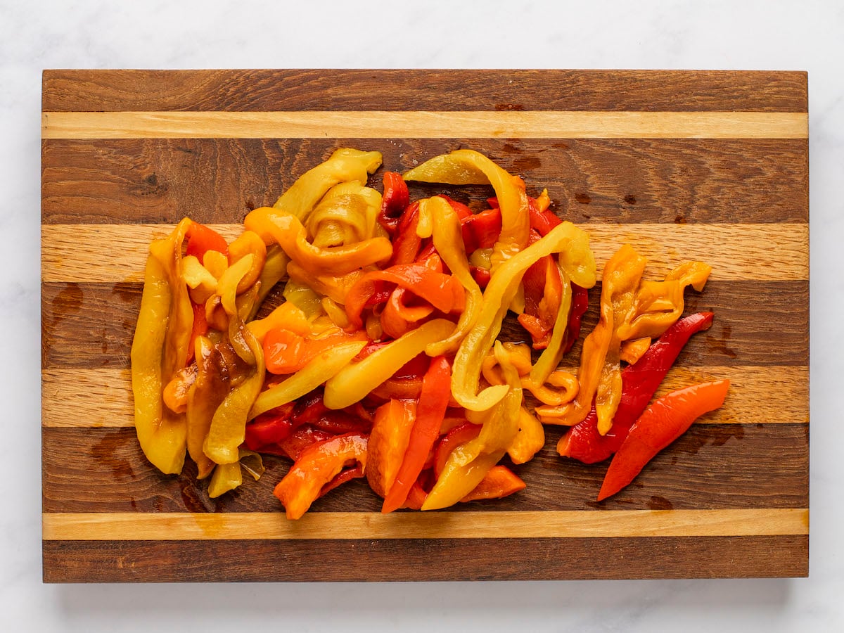 sliced peppers on wooden cutting board.