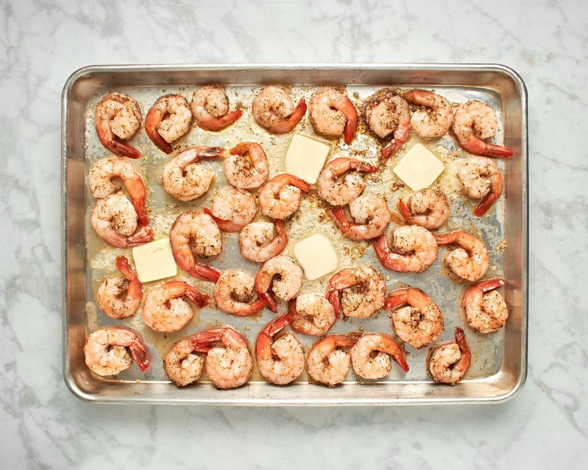 butter and shrimp on baking sheet.