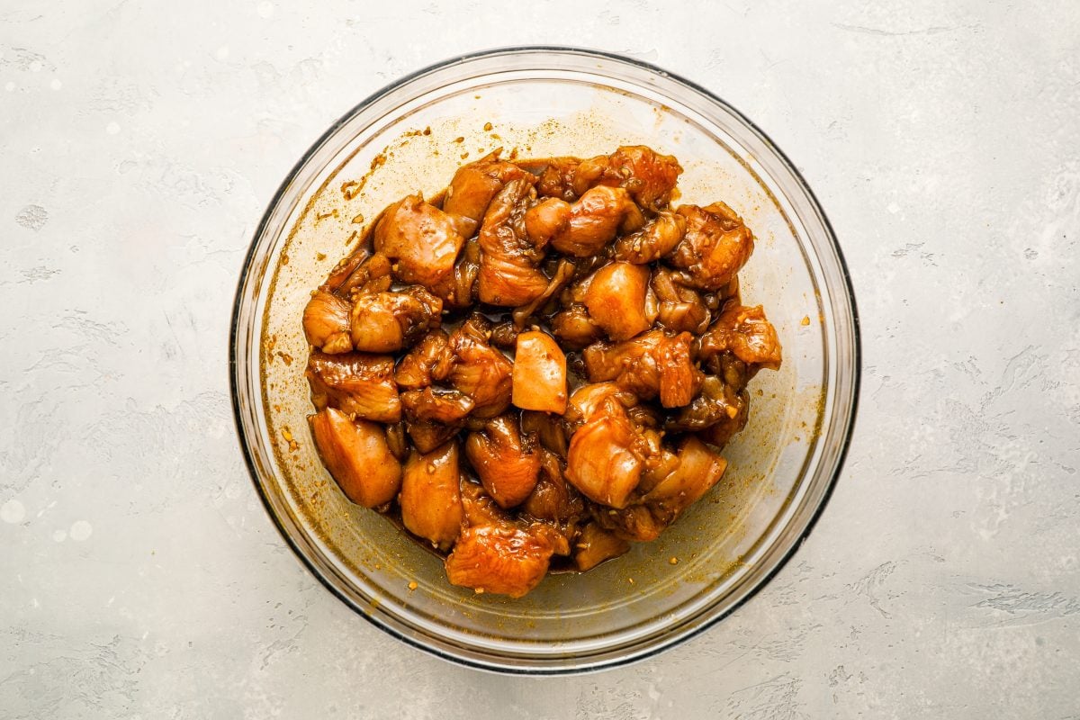 marinating the chicken pieces in a bowl.