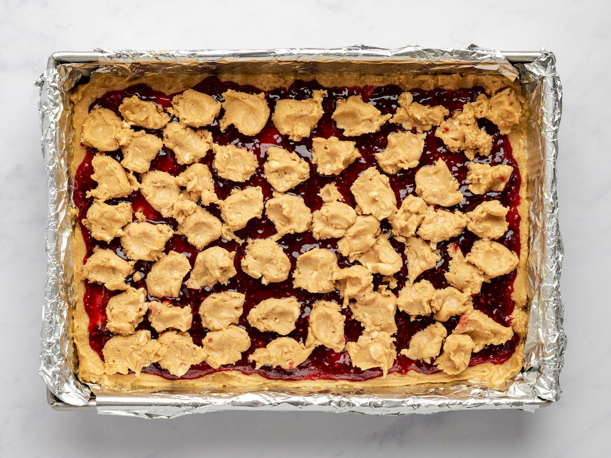 ½- to 1-inch clumps of remaining dough spread over the jam in 9x13-inch pan