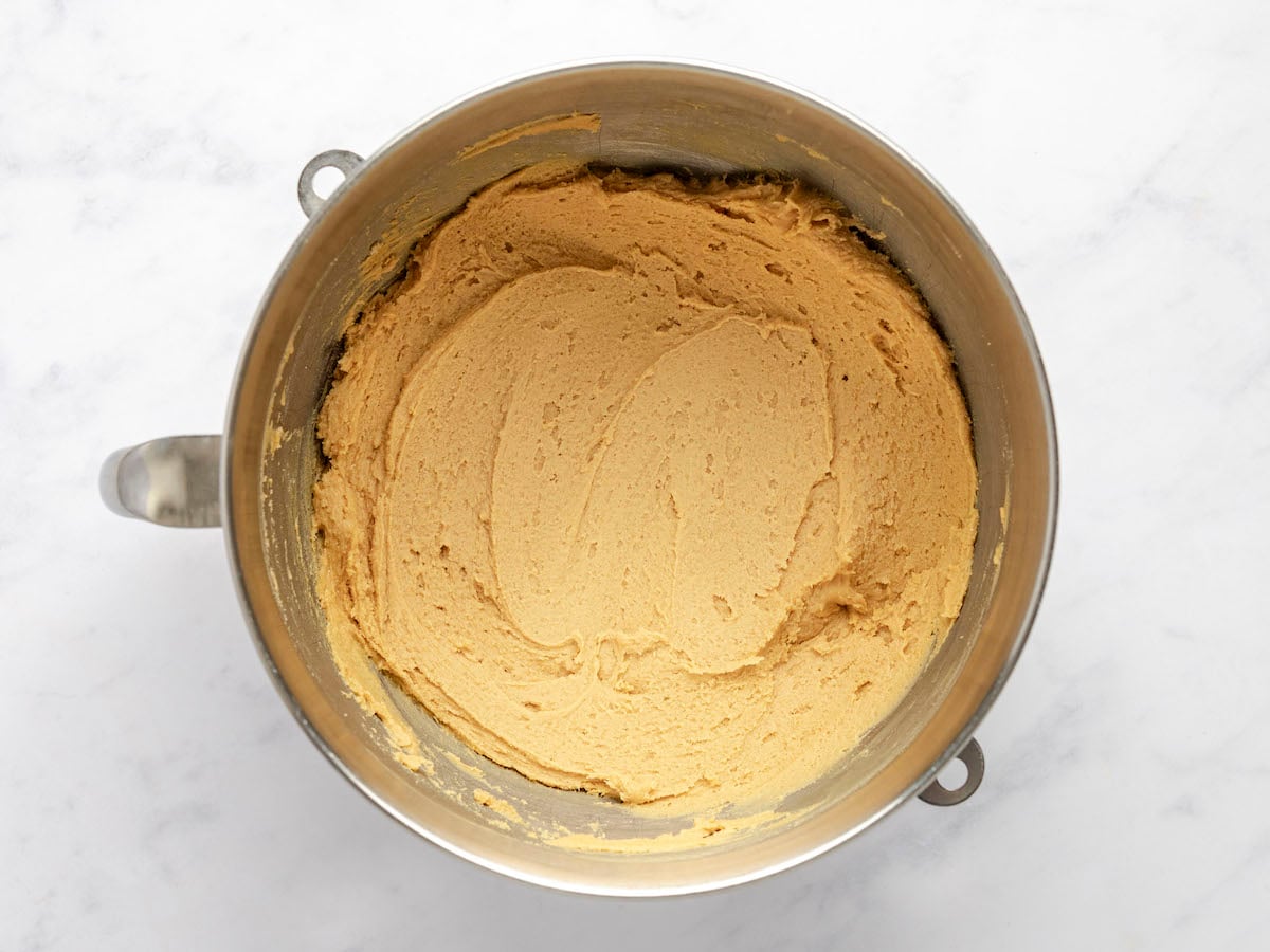 mixing bowl with flour combined with sugar, butter, and egg mixture