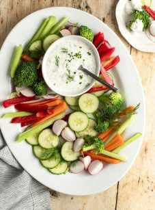 bowl of ranch dressing on platter of vegetables.