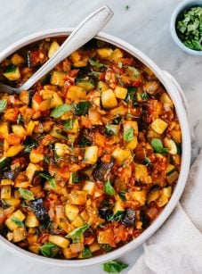 bowl of ratatouille with spoon and white linen napkin